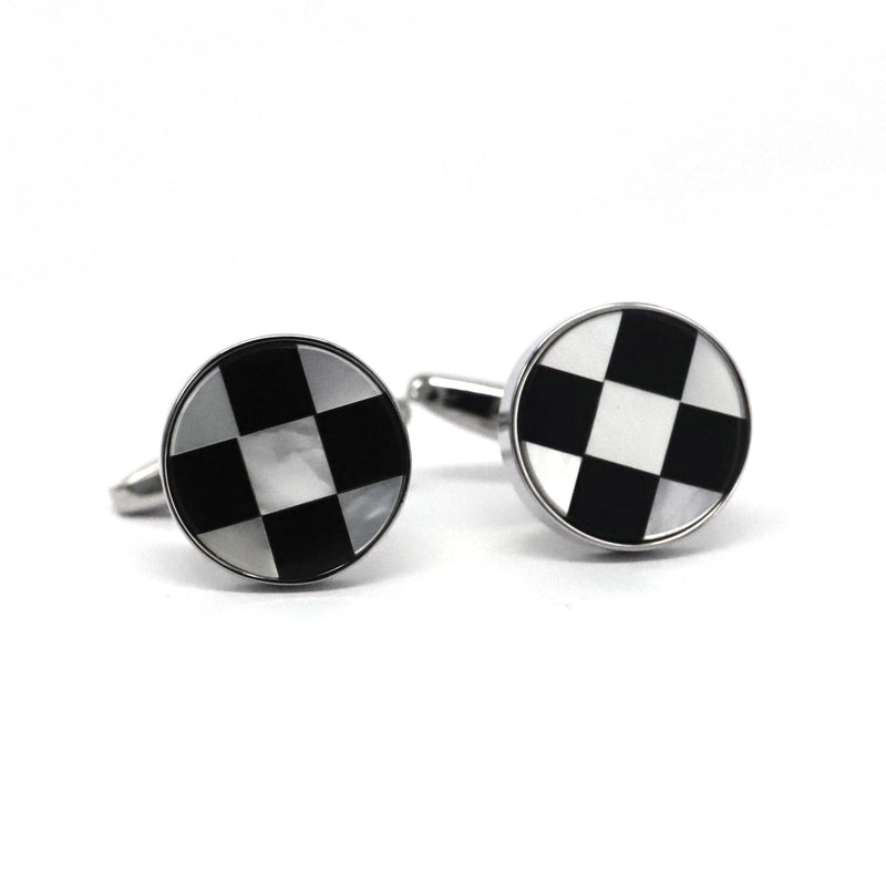 A pair of round silver white cufflinks with a black and white chess design, rhodium plated copper alloy, displayed against a white background.