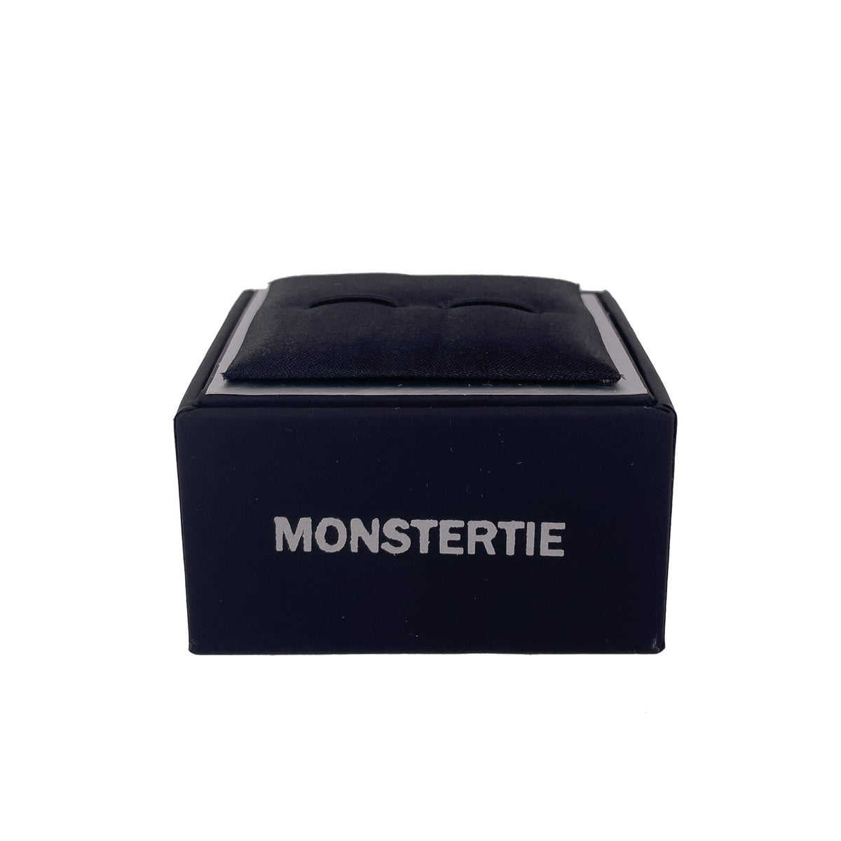 Designer cufflinks box by MonsterTie, showcasing a sleek black design with plush cushioning.